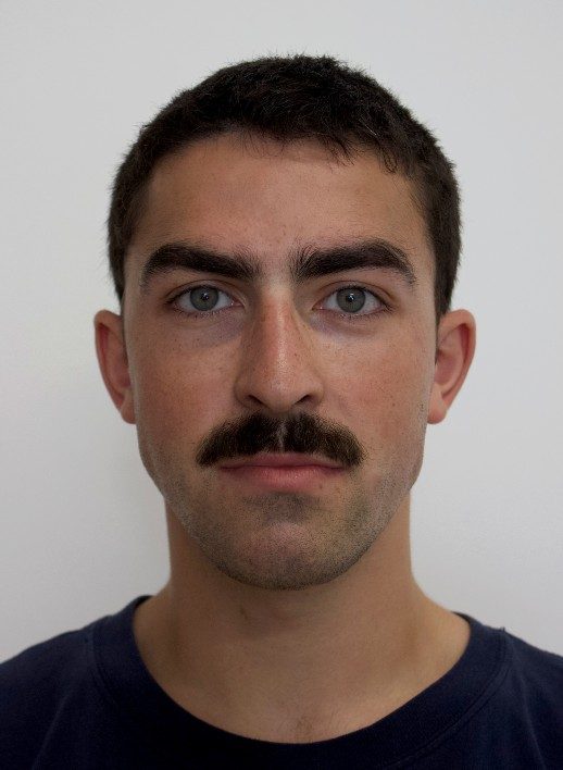 Finlay-Jenner-headshot-TallulahPollock-518x708 A photograph of a young person with short brown hair and a mustache