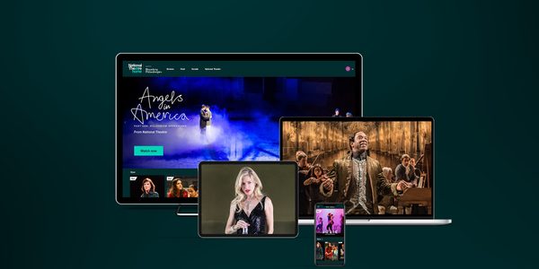 National Theatre At Home - Unmissable Theatre, whenever you want it. A variety of devices including a desktop computer, laptop, tablet, and smartphone display different scenes from theatrical productions. The desktop shows