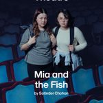 Two young women standing in an empty theater with blue seats, looking at the camera. Text above them reads 