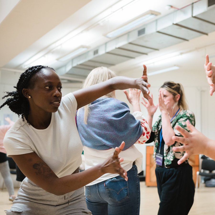 23-Paper-Birds-Lighting-DramaTeacherConference-Emma-Hare Two teachers moving their hand in the air for a workshop during Drama Teacher Conference 2023