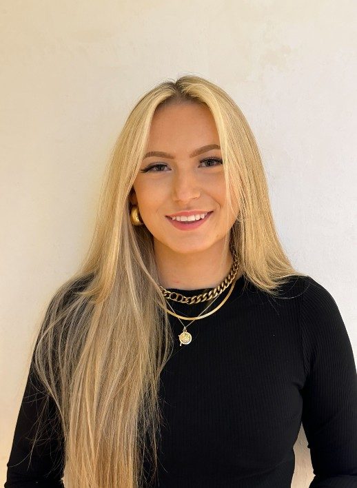Tallulah-Caskey-headshot-TallulahCaskey-518x708 A person with very long blonde hair wearing a long-sleeved black top